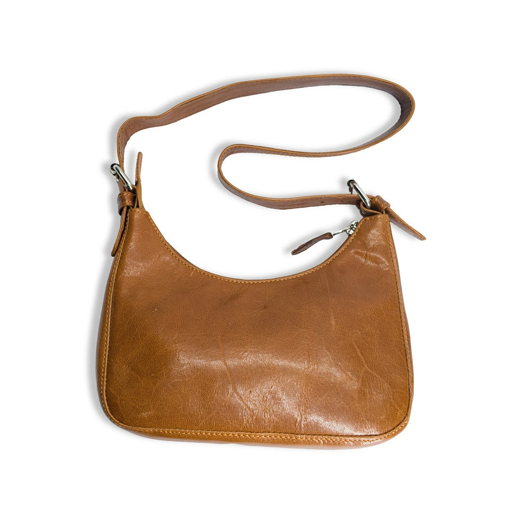 Flat lay view of the tan leather hobo bag showcasing its sleek shape and texture