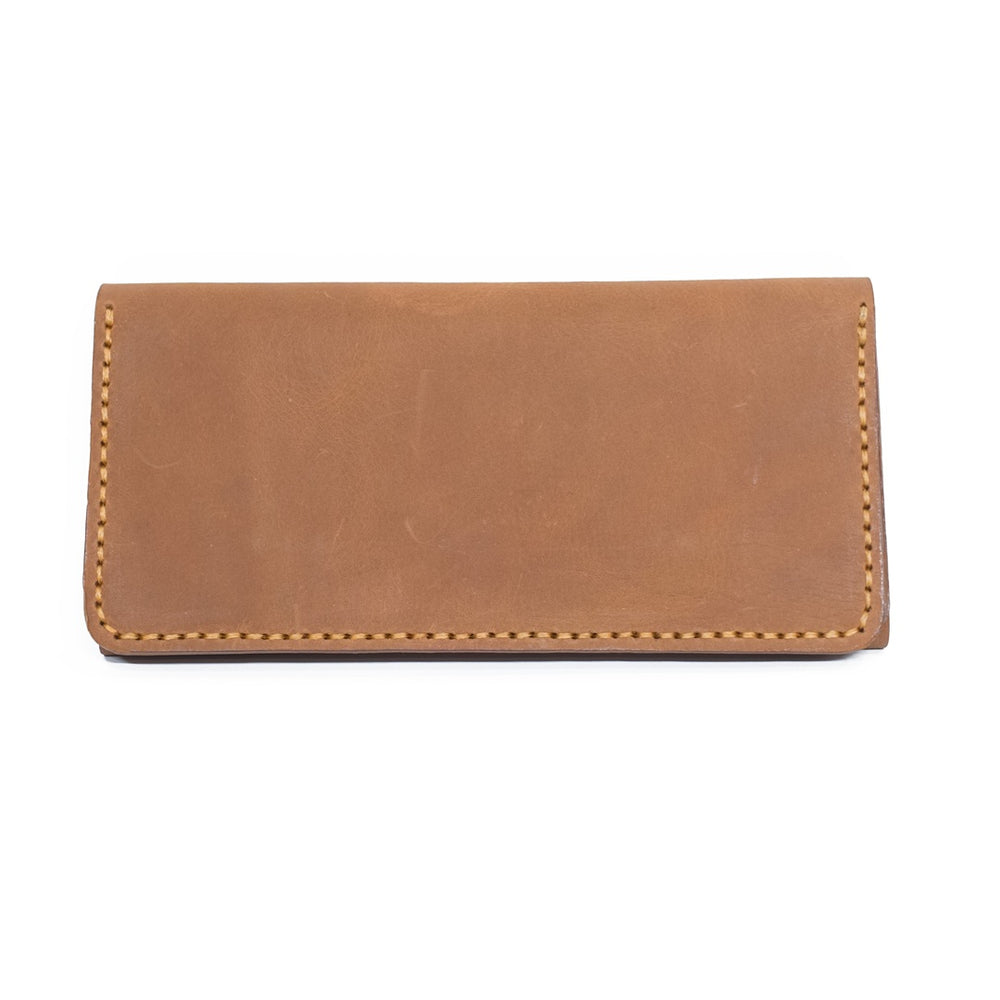 Brut & Beau closed tan full-grain leather long wallet flat exterior view with contrast perimeter stitching