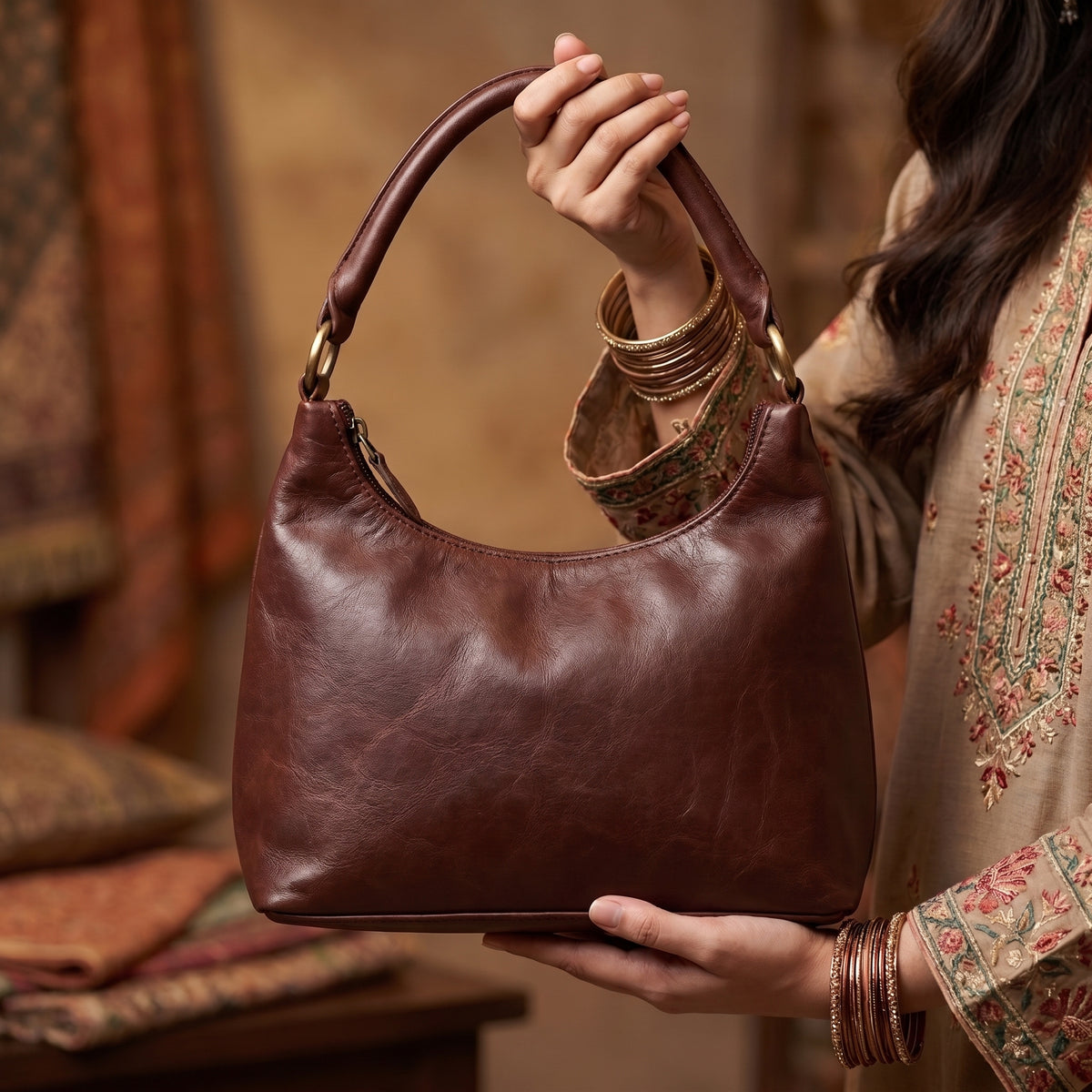 Model styling a premium brown leather crossbody handbag from Brut & Beau