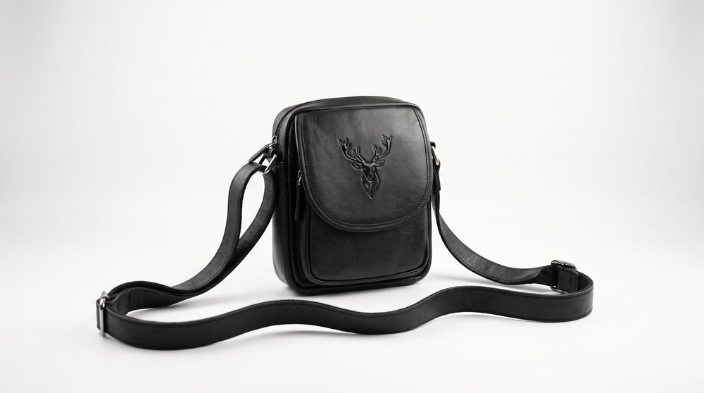 Black leather men's crossbody bag with stag logo on a white background