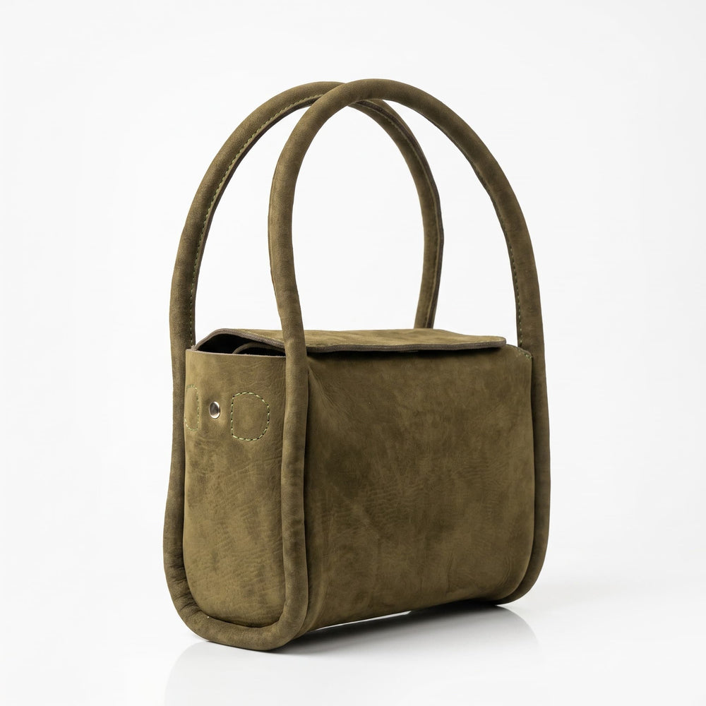 Side angle of olive green genuine leather handbag showing structured silhouette