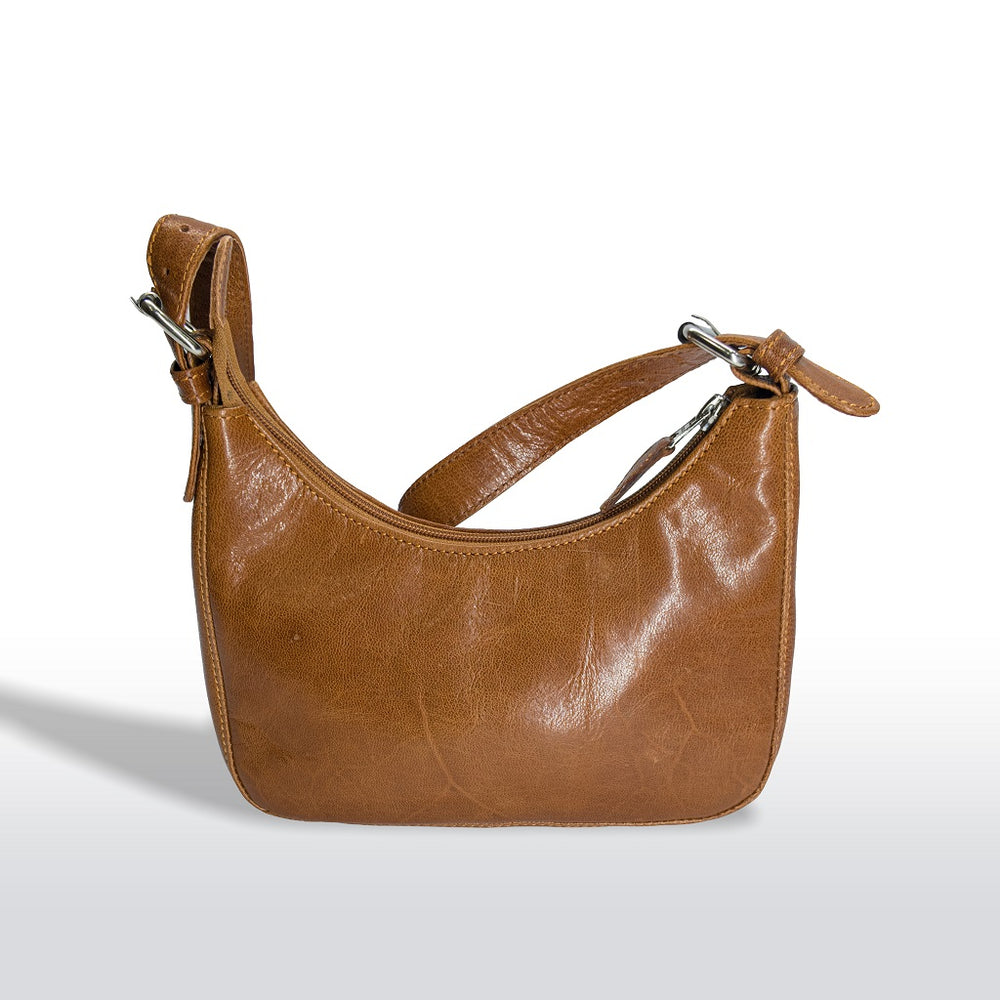 Front profile view of a brown tan leather hobo handbag with silver hardware