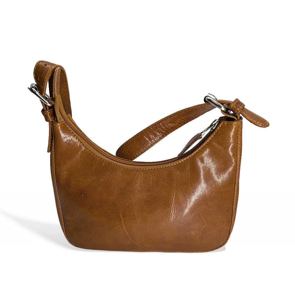 Front profile view of a brown tan leather hobo handbag with silver hardware