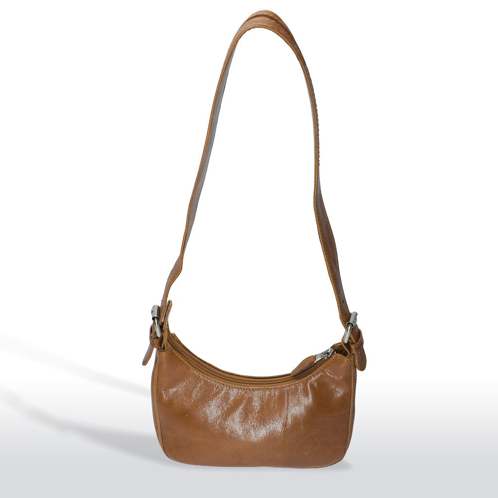 Full view of the tan leather shoulder bag hanging to show strap length